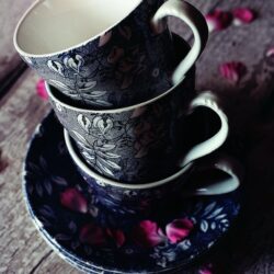 three black floral teacups