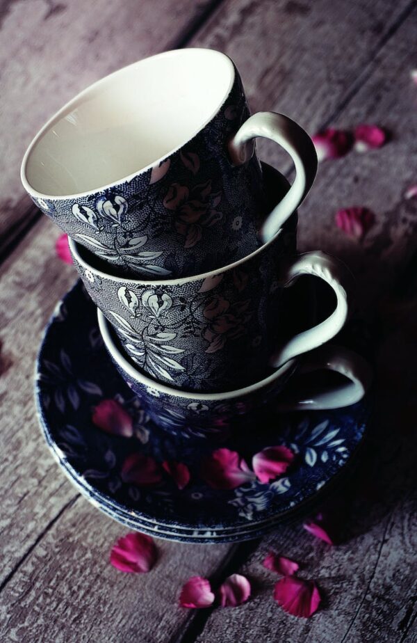 three black floral teacups