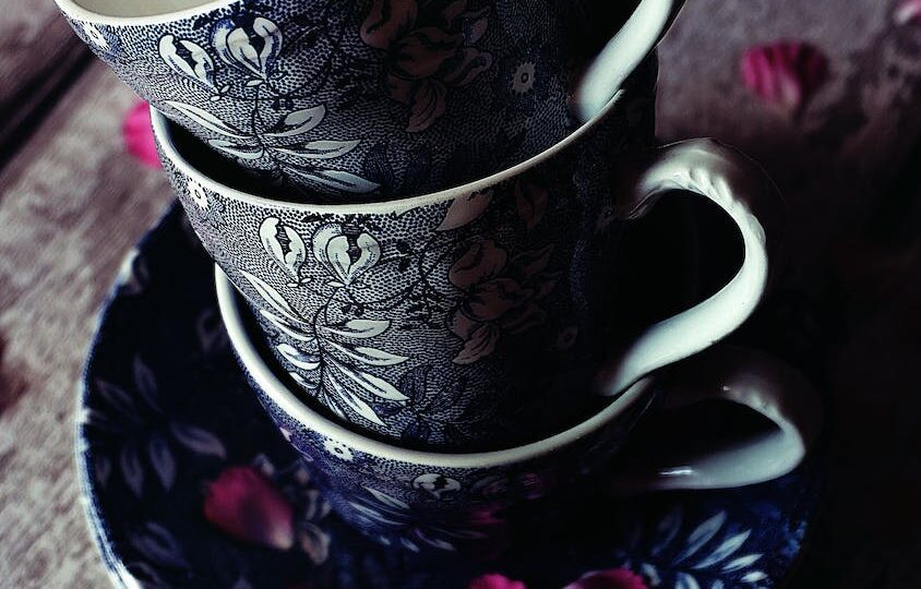 three black floral teacups